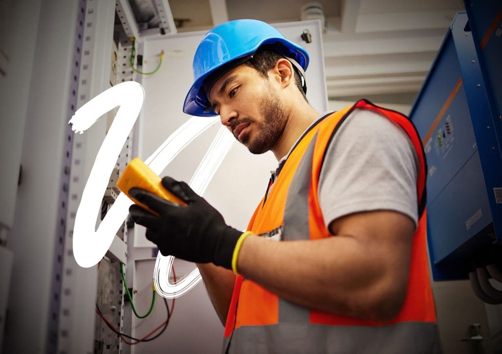Industrial electrician inspecting control systems equipment in a heavy industry environment